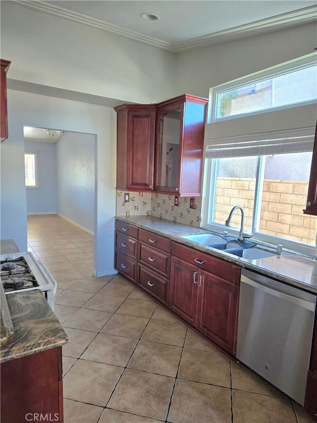 kitchen with sink, light tile patterned floors, ornamental molding, and dishwasher