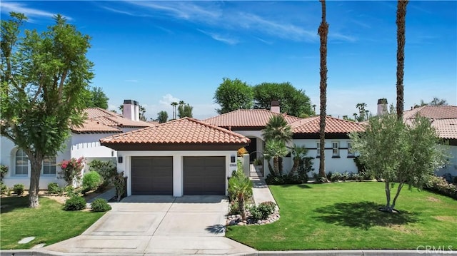 mediterranean / spanish home with a front yard and a garage