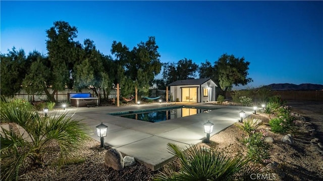 view of swimming pool featuring a mountain view, a patio, and an outdoor structure