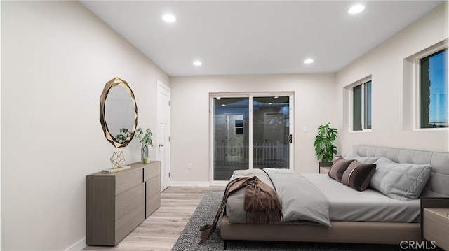 bedroom featuring access to exterior and light hardwood / wood-style floors