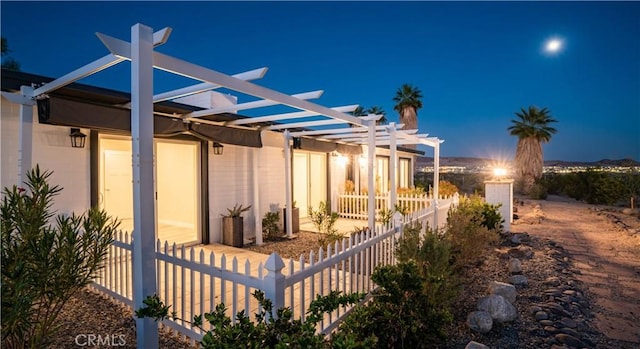 view of side of property featuring a pergola