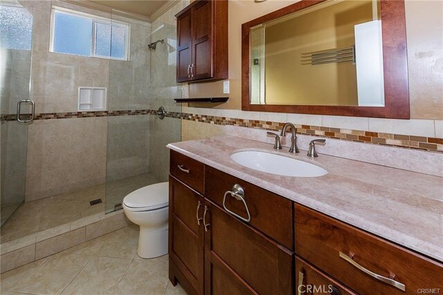 7716 Owensmouth Ave, Canoga Park, CA 91304 - bathroom featuring a shower stall, toilet, vanity, tile patterned flooring, and decorative backsplash
