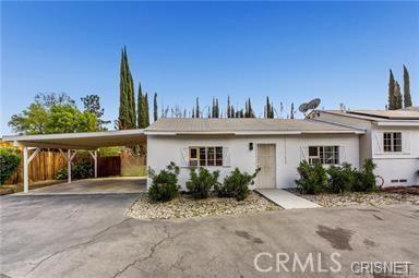 7716 Owensmouth Ave, Canoga Park, CA 91304 - single story home with driveway, an attached carport, and stucco siding