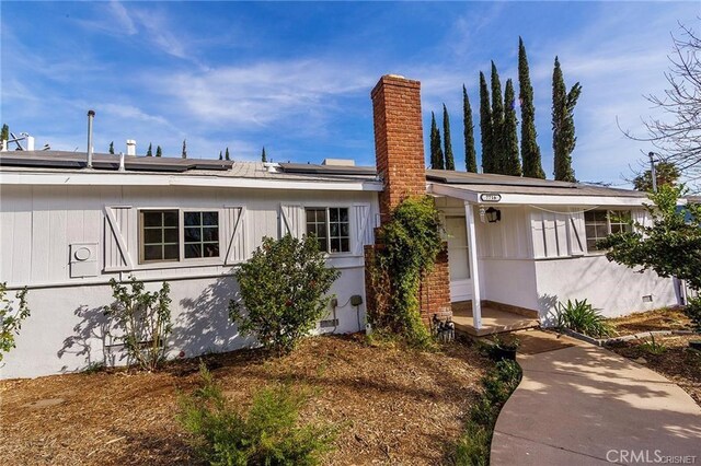 7716 Owensmouth Ave, Canoga Park, CA 91304 - view of front facade featuring a chimney and solar panels