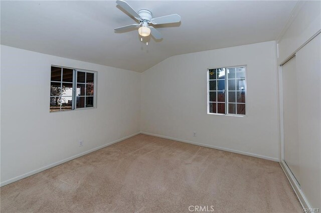 7716 Owensmouth Ave, Canoga Park, CA 91304 - spare room featuring light colored carpet, vaulted ceiling, a ceiling fan, and baseboards