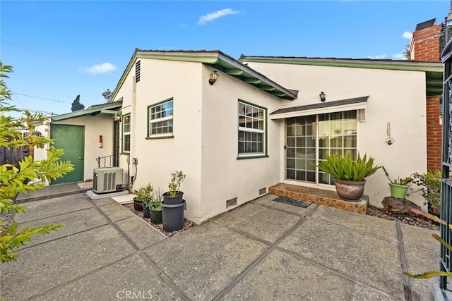 rear view of property featuring central air condition unit and a patio area