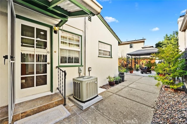 exterior space with central AC and a patio