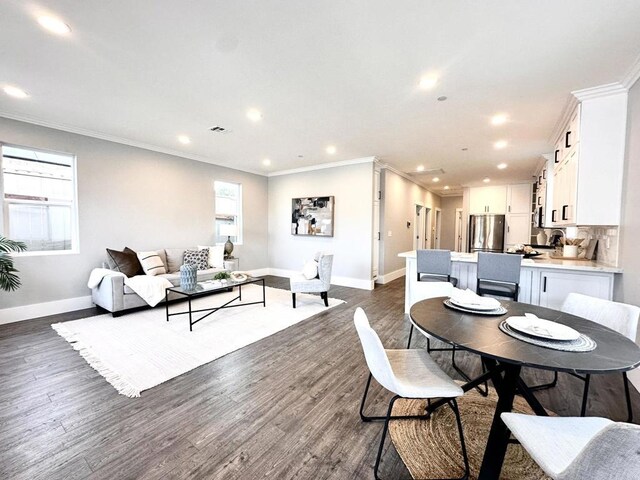 dining area featuring dark hardwood / wood-style floors and crown molding