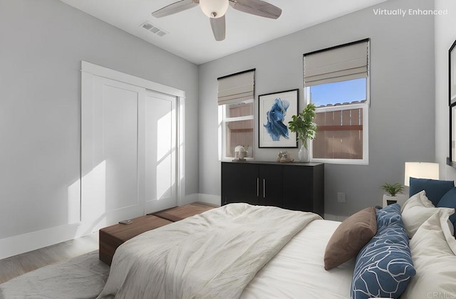 bedroom with visible vents, ceiling fan, baseboards, and wood finished floors