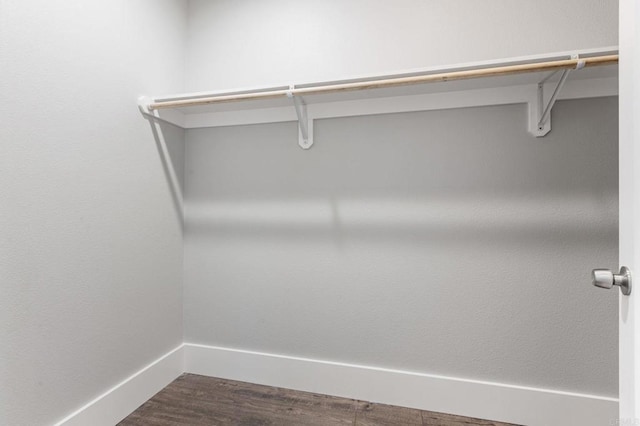 walk in closet featuring dark wood-type flooring