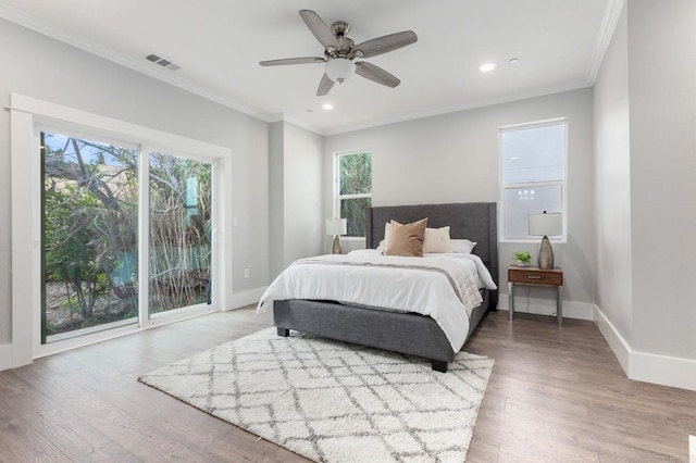 bedroom with access to outside, wood finished floors, baseboards, and ornamental molding