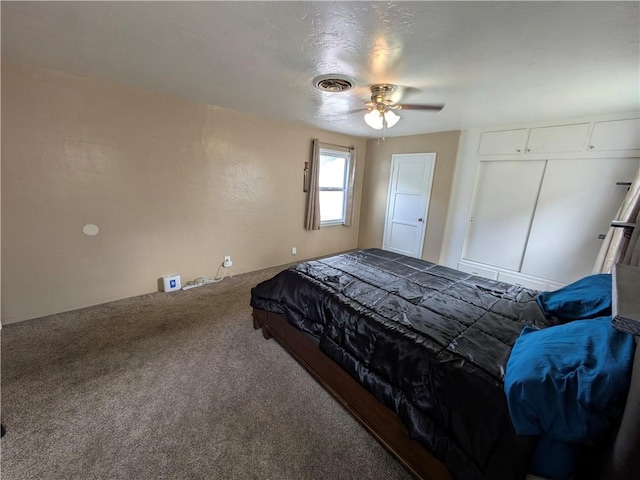 bedroom with ceiling fan, visible vents, and carpet