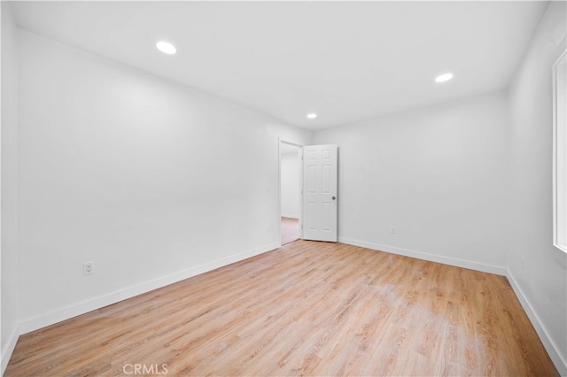 spare room with light hardwood / wood-style floors