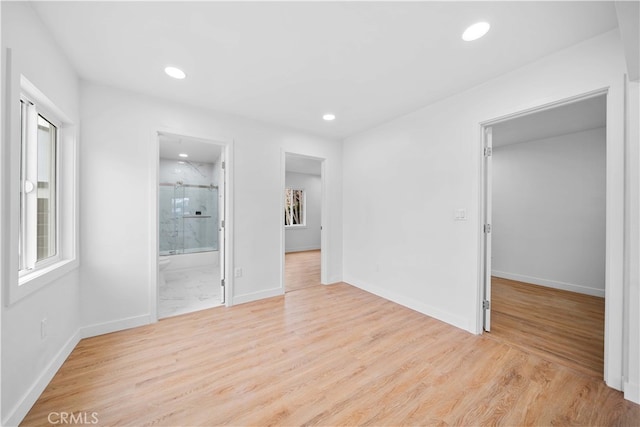 unfurnished room with a wealth of natural light and light hardwood / wood-style floors