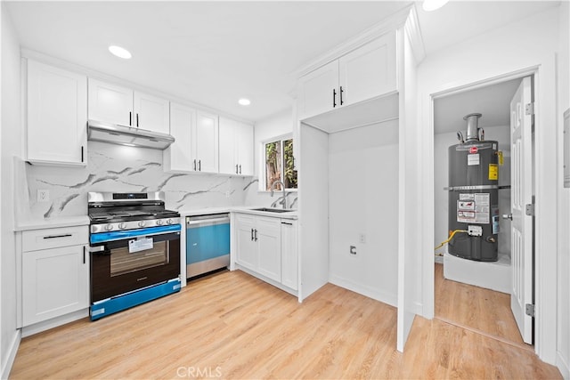 kitchen with appliances with stainless steel finishes, strapped water heater, and white cabinetry