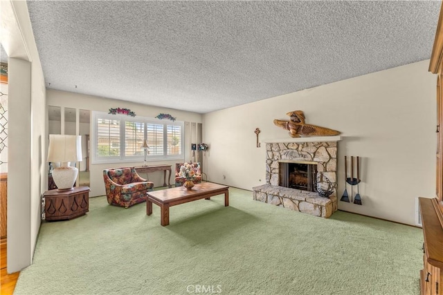 carpeted living room featuring a stone fireplace and a textured ceiling