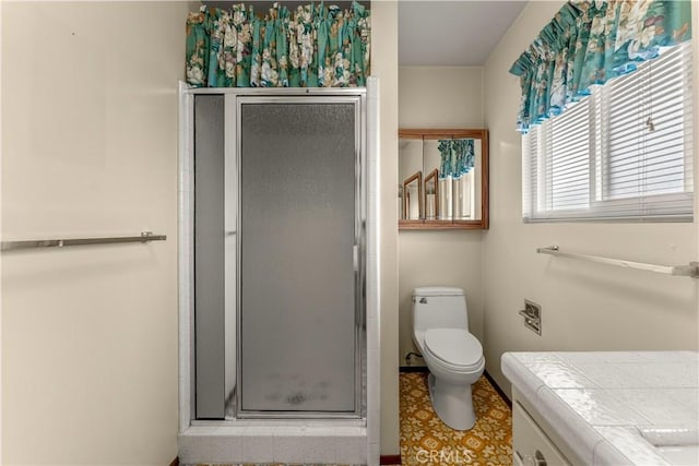 bathroom with toilet, vanity, and walk in shower