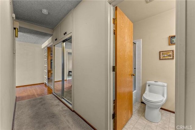 corridor featuring a textured ceiling