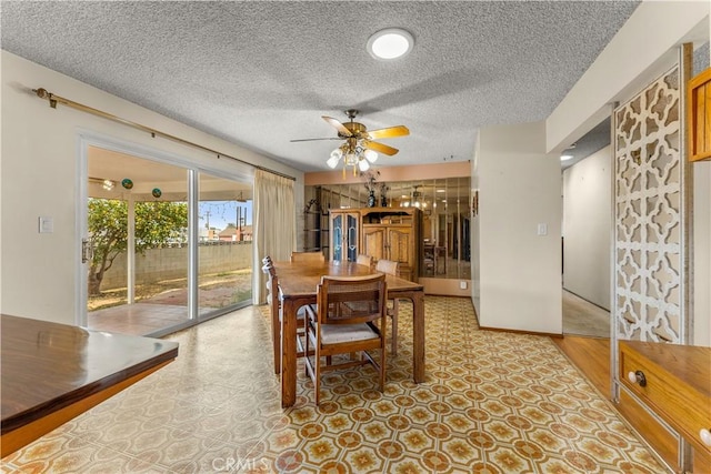 dining area with ceiling fan and a textured ceiling