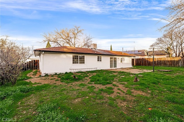 back of house with a yard and central AC unit