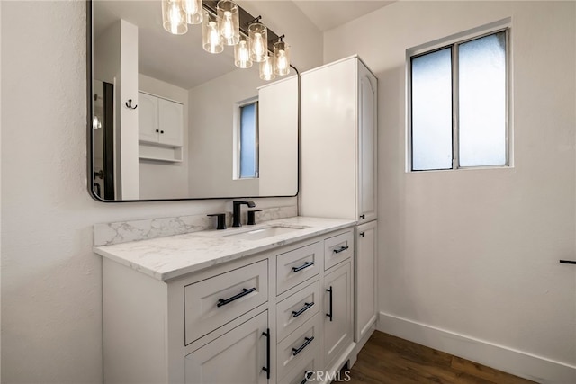 bathroom featuring plenty of natural light, hardwood / wood-style floors, and vanity