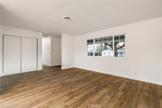 unfurnished bedroom featuring a closet and wood-type flooring