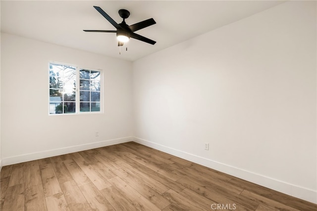 empty room with ceiling fan and light hardwood / wood-style floors