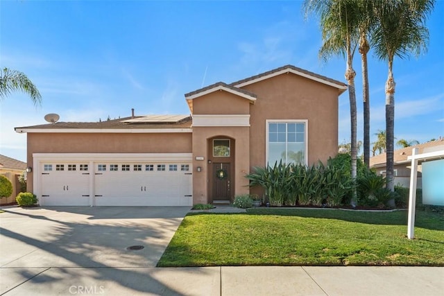 view of front of property featuring a garage and a front yard