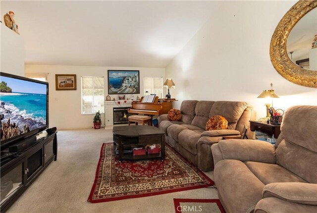 living room featuring carpet and vaulted ceiling