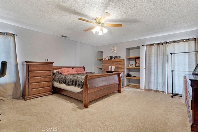 carpeted bedroom with a textured ceiling and ceiling fan