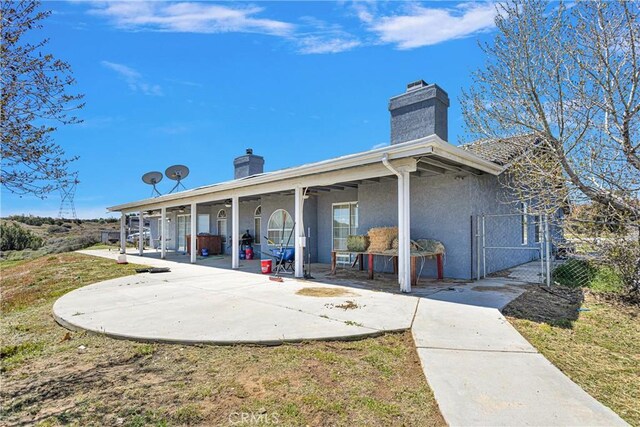 rear view of house with a patio area and a yard