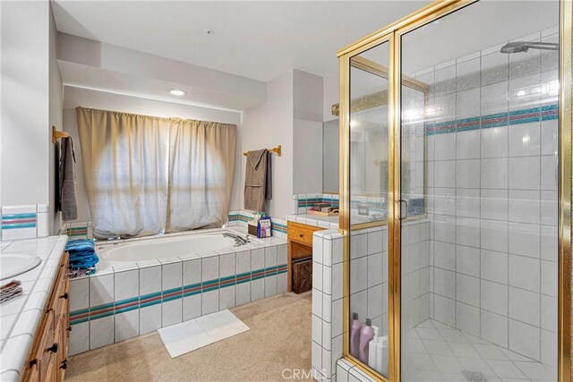 bathroom featuring separate shower and tub and vanity