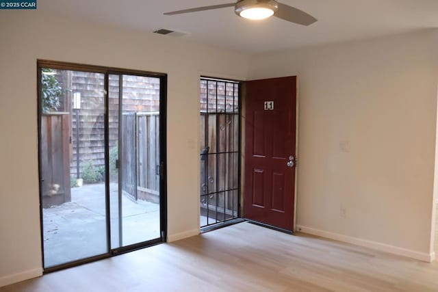 doorway with ceiling fan, light hardwood / wood-style floors, and a wealth of natural light