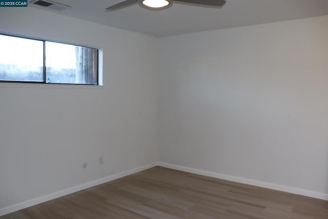 empty room with ceiling fan and hardwood / wood-style floors