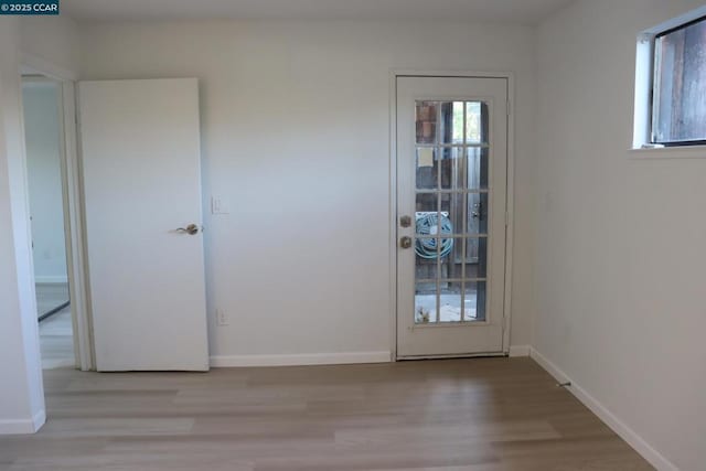 doorway to outside with light wood-type flooring