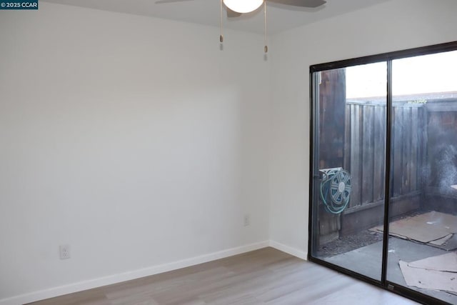 empty room featuring ceiling fan and light wood-type flooring