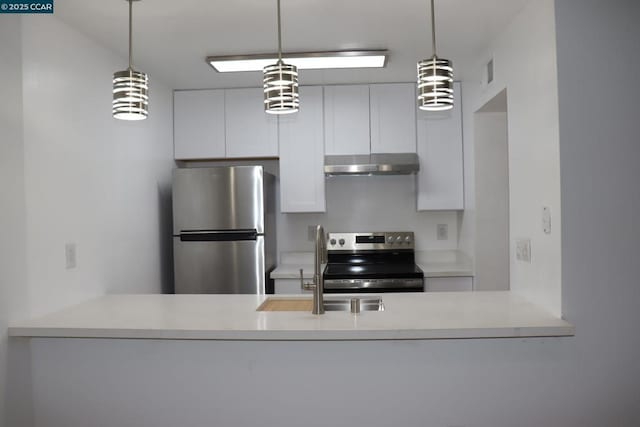 kitchen featuring decorative light fixtures, sink, white cabinetry, and appliances with stainless steel finishes