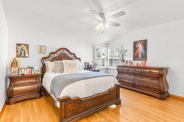 bedroom with vaulted ceiling, ceiling fan, and light hardwood / wood-style flooring