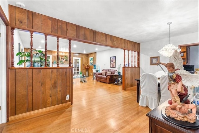 living room with a notable chandelier and light hardwood / wood-style flooring