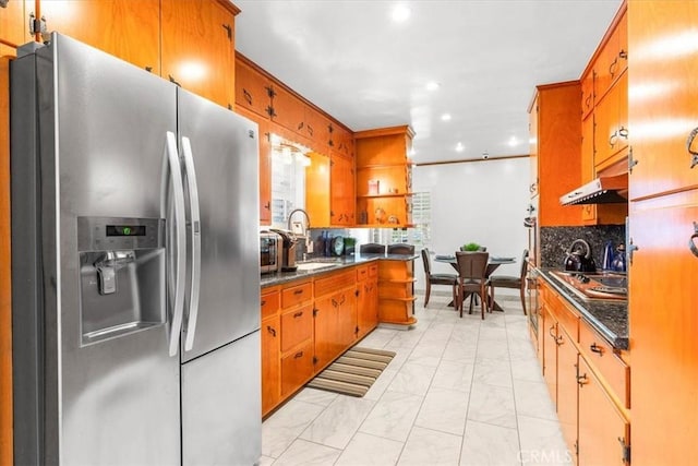 kitchen featuring backsplash, appliances with stainless steel finishes, and sink