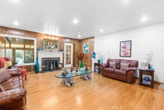 living room featuring a premium fireplace and light hardwood / wood-style flooring