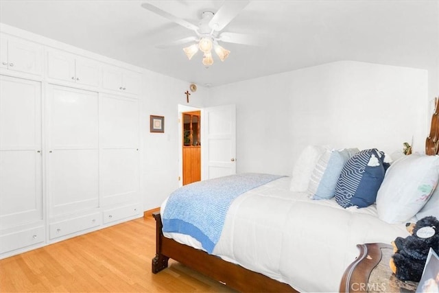 bedroom featuring ceiling fan, a closet, and light wood-type flooring