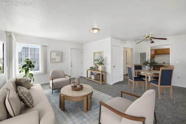 carpeted living room with ceiling fan