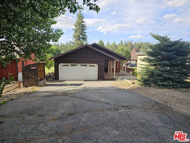 exterior space featuring a garage and an outdoor structure