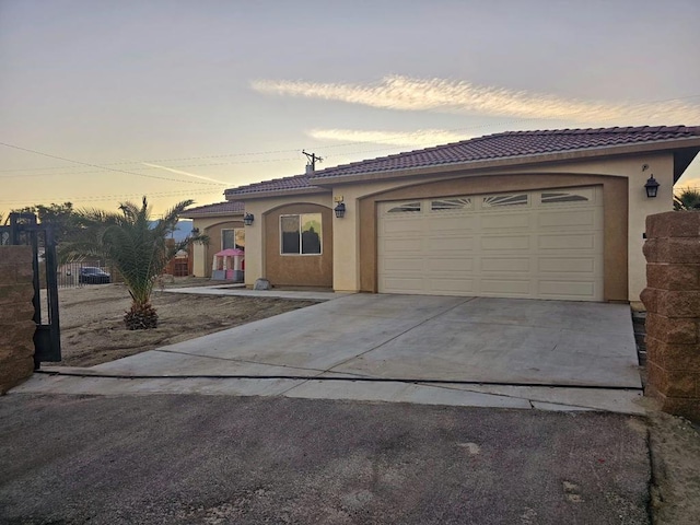 mediterranean / spanish-style house with a garage