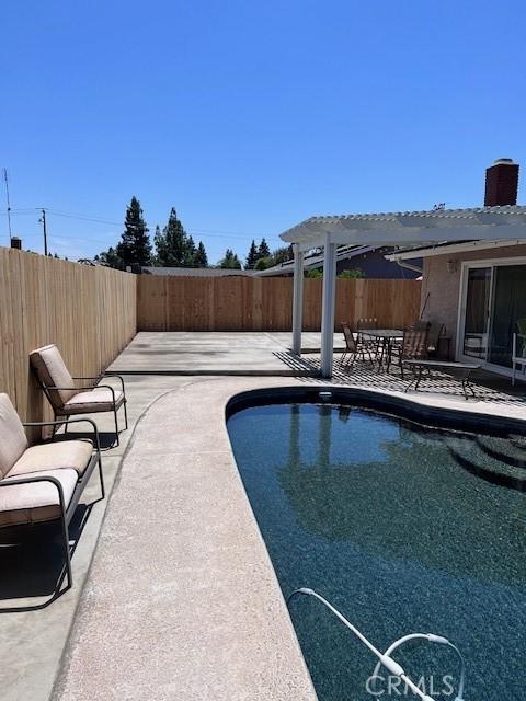 view of pool featuring a pergola and a patio