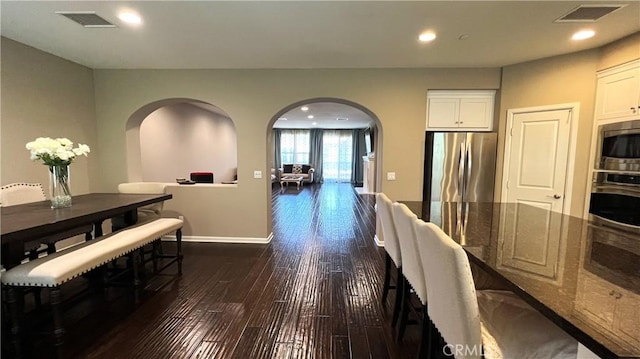 dining space with dark hardwood / wood-style floors