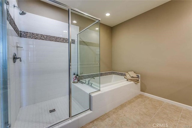 bathroom featuring shower with separate bathtub