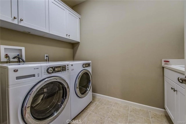 washroom featuring cabinets and separate washer and dryer