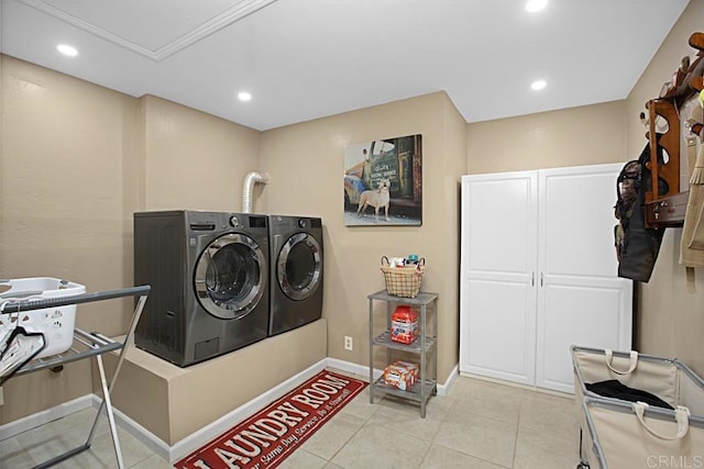 laundry area featuring cabinets, independent washer and dryer, and light tile patterned flooring